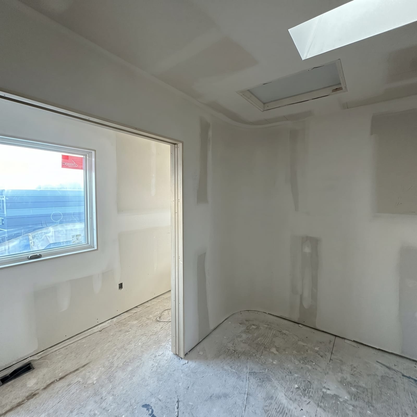 Custom drywall installation with skylight integration and curved corner details Toronto home